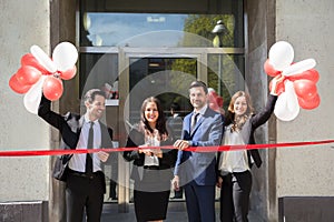 Businesspeople Cutting Red Ribbon