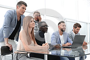 Businesspeople with digital computer having meeting In office