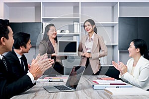 Businesspeople discussing at conference office desk, business team clapping hands to admire compliment during successful