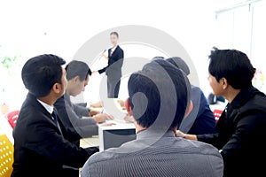 Businesspeople discussing at conference office desk, businesspeople listening to presentation, brainstorming at group board