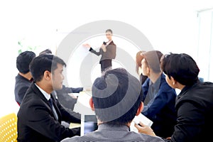 Businesspeople discussing at conference office desk, businesspeople listening to presentation, brainstorming at group board