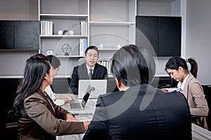 Businesspeople discussing at conference office desk, happy businessman and businesswoman brainstorming at group board meeting,