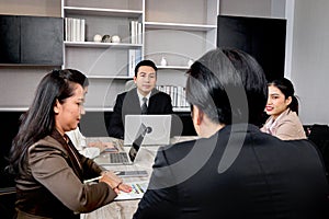 Businesspeople discussing at conference office desk, happy businessman and businesswoman brainstorming at group board meeting,