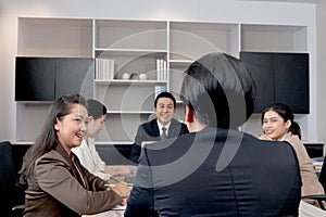 Businesspeople discussing at conference office desk, happy businessman and businesswoman brainstorming at group board meeting,