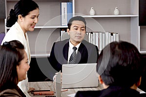 Businesspeople discussing at conference office desk, happy businessman and businesswoman brainstorming at group board meeting,