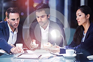 Businesspeople discussing over digital tablet