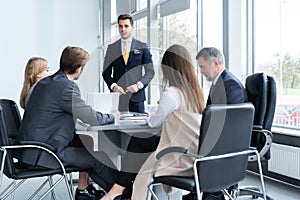 Businesspeople discussing together in conference room during meeting at office.