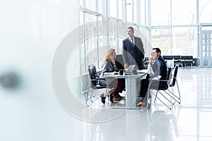 Businesspeople discussing together in conference room during meeting at office.