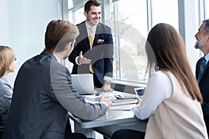 Businesspeople discussing together in conference room during meeting at office.