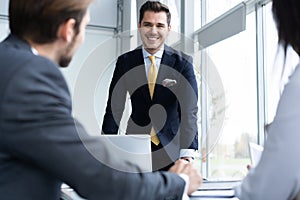 Businesspeople discussing together in conference room during meeting at office.