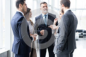 Businesspeople discussing together in conference room during meeting at office.