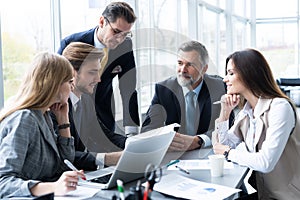 Businesspeople discussing together in conference room during meeting at office.