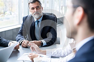 Businesspeople discussing together in conference room during meeting at office.