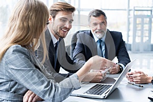 Businesspeople discussing together in conference room during meeting at office.