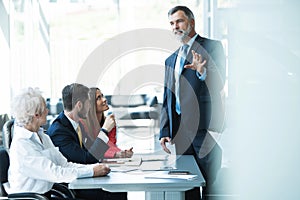 Businesspeople discussing together in conference room during meeting at office.