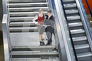 Businesspeople Discussing Work On Stairs