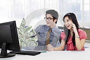 Businesspeople earn money online on computer