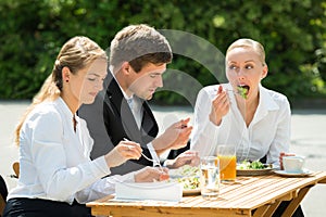 Businesspeople Eating Food In Restaurant