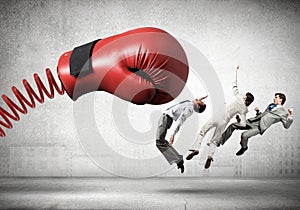 Businesspeople fighting with boxing glove