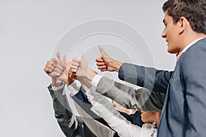 businesspeople in formal wear showing thumbs up