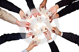 Businesspeople Hand Holding Jigsaw Puzzle