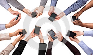 Group Of Hands Using Cell Phone