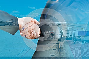 Businesspeople handshake with aeroplane in airport