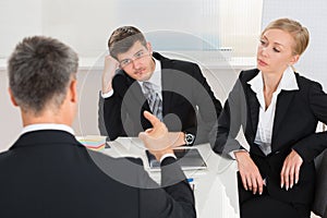 Businesspeople Having Argument At Workplace photo