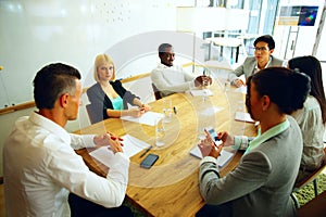 Businesspeople having meeting around table