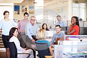 Businesspeople Having Meeting In Modern Open Plan Office