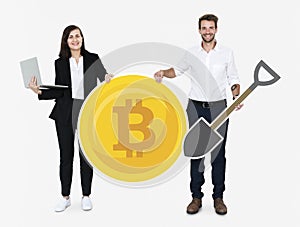 Businesspeople holding bitcoin cryptocurrency and mining concept icons