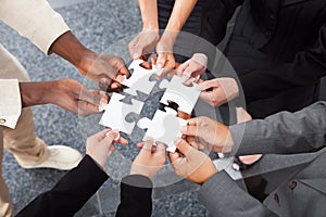 Businesspeople holding jigsaw puzzle