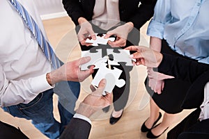 Businesspeople holding jigsaw puzzle