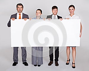 Businesspeople Holding Placard