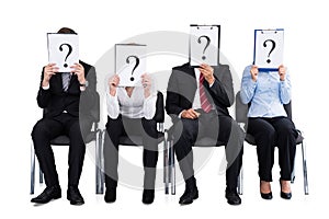 Businesspeople Holding Question Mark Sign