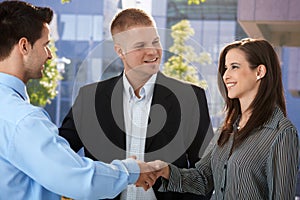 Businesspeople introducing outside of office photo