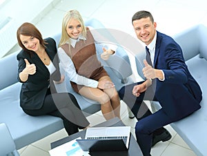 Businesspeople With Laptop Having Meeting In Office