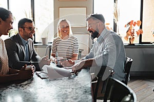 Businesspeople laughing in an office lounge