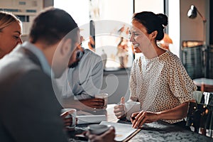 Businesspeople laughing over coffee