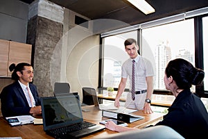 Businesspeople with leader discussing together in conference room during meeting at office.