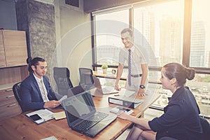 Businesspeople with leader discussing together in conference room during meeting at office.