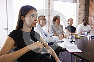 Businesspeople Listening To Presentation In Boardroom