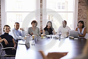 Businesspeople Listening To Presentation In Boardroom