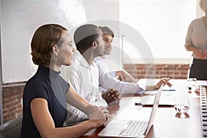 Businesspeople Listening To Presentation In Boardroom