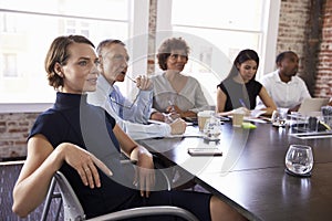 Businesspeople Listening To Presentation In Boardroom