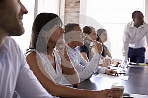 Businesspeople Listening To Presentation In Boardroom