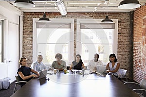 Businesspeople Listening To Presentation In Boardroom