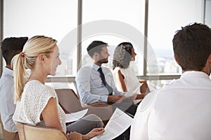 Businesspeople Listening To Presentation In Office