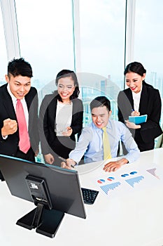 Businesspeople looking at computer in the office