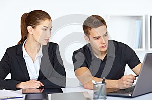 Businesspeople looking at computer screen